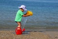 Little girl playing with toys on the beach