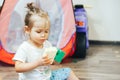 little girl playing toys at home in white t-shirt Royalty Free Stock Photo