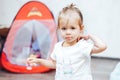 little girl playing toys at home in white t-shirt Royalty Free Stock Photo