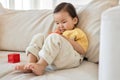 Little girl playing toys on sofa Royalty Free Stock Photo