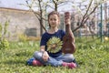 A little girl playing ukulele in the garden. Royalty Free Stock Photo