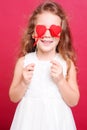 Little girl playing with valentines hearts Royalty Free Stock Photo