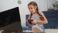 little girl playing video game on gamepad. kid dream stay home computer addiction. girl playing tablet video online Royalty Free Stock Photo