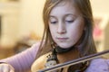 Little girl playing the violin at home. Child or little girl playing violin indoors at home Royalty Free Stock Photo