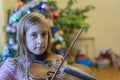 Little girl playing the violin at home. Child or little girl playing violin indoors at home Royalty Free Stock Photo