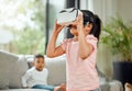 A countdown to the end of a quiet storm. a little girl playing with a virtual reality headset while her brother watches