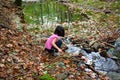 Little girl playing with water in a river Royalty Free Stock Photo