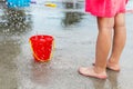 Little girl playing at water splash pad fountain in the park playground during hot summer day Royalty Free Stock Photo