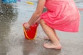 Little girl playing at water splash pad fountain in the park playground during hot summer day Royalty Free Stock Photo