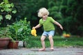 Little girl playing with watering can Royalty Free Stock Photo