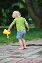 Little girl playing with watering can Royalty Free Stock Photo