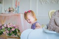 Little girl playing with white wooden rocking horse and bear doll Royalty Free Stock Photo
