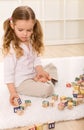 Little girl playing with wooden blocks Royalty Free Stock Photo