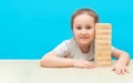 Little girl playing with wooden jenga game