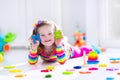 Little girl playing with wooden toys Royalty Free Stock Photo