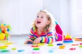 Little girl playing with wooden toys Royalty Free Stock Photo