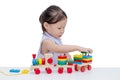 Little girl playing with wooden train toy Royalty Free Stock Photo