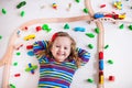 Little girl playing with wooden trains Royalty Free Stock Photo