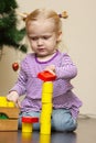 Little girl playng with toy blocks