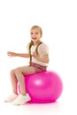 Little girl plays with a big ball for fitness Royalty Free Stock Photo