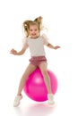 Little girl plays with a big ball for fitness Royalty Free Stock Photo