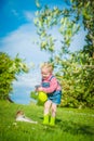 Little girl plays with a cat on a green grass Royalty Free Stock Photo