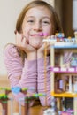 Little girl plays with a children`s constructor at home. Little girl playing with lots of colorful plastic blocks Royalty Free Stock Photo