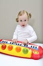 Little girl plays on a children's keyboard Royalty Free Stock Photo