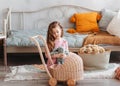 A little girl plays with dolls and a stroller in a children`s bedroom. Games for children Royalty Free Stock Photo