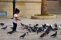 A little girl plays feeding pigeons in Heraklion Royalty Free Stock Photo