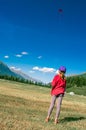 Little girl plays with her kite in large mountain meadows Royalty Free Stock Photo