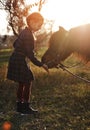 Little girl plays with horse