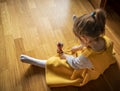 Little girl plays with the kendama