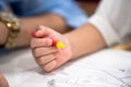 Little girl plays and learns to coloring Crayon on the paper in the ice-cream restaurant., Bangkok, Thailand