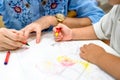 Little girl plays and learns to coloring Crayon on the paper in the ice-cream restaurant., Bangkok, Thailand