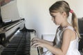 Girl plays piano Royalty Free Stock Photo