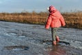 Little girl plays in puddle, children, fun, unforgettable moments, dirty and wet shoes, fun with father, life in village, sunlig Royalty Free Stock Photo