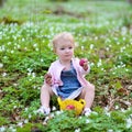 Little girl plays in spring forest at Easter Royalty Free Stock Photo