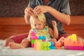 little girl plays toy constructor father brushes her hair Royalty Free Stock Photo