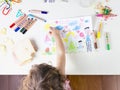 Little girl point at a sun in a kids drawing of multi-racial Family Royalty Free Stock Photo