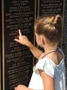 Little girl points to a loved ones name on EAA Memorial Wall in Oshkosh, WI