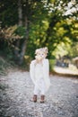 Little girl in a poncho eating yellow juicy pear Royalty Free Stock Photo