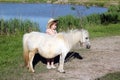 Little girl and pony horse Royalty Free Stock Photo