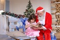 Grandfather playing Santa Claus role for granddaughter.