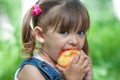 Little girl portrait eating apple outdoor Royalty Free Stock Photo