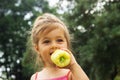 Little girl portrait eating pepper outdoor