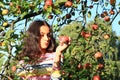 Girl under apple tree holding apple Royalty Free Stock Photo