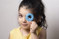 Little girl portrait peeking through English Q letter