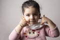 Little girl portrait removing hospital mask from her face