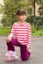 Little girl portrait summer outdoors on the rollers